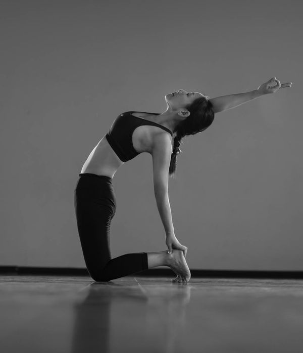 Woman in a flowing yoga pose, demonstrating flexibility and control.